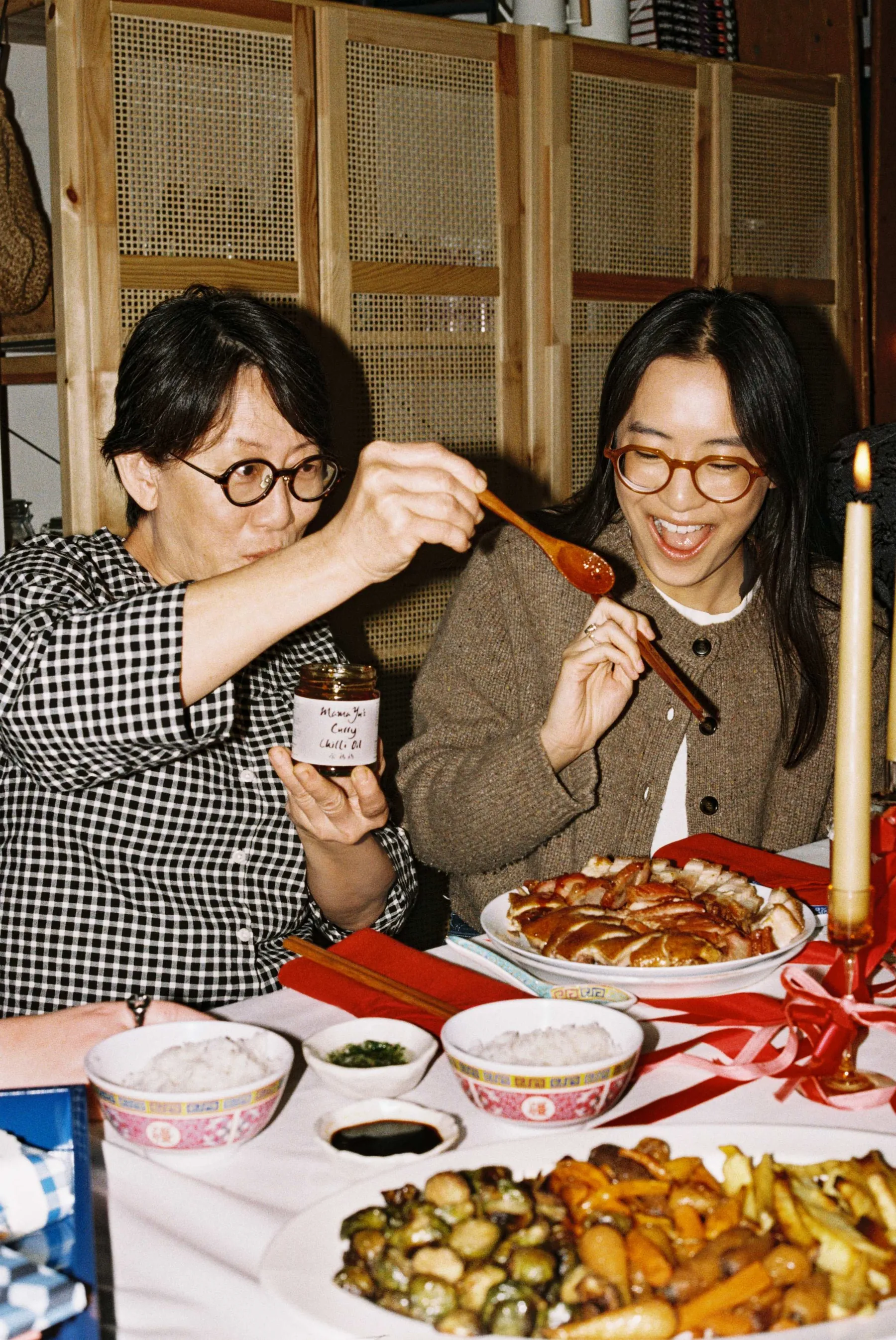 Jolene and Xien sharing Mama Yu chilli oil around the dinner table
